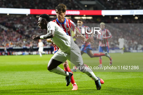 Vinicius Junior left winger of Real Madrid and Brazil and Robin Le Normand centre-back of Atletico de Madrid and Spaincompete for the ball d...