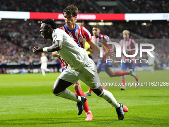 Vinicius Junior left winger of Real Madrid and Brazil and Robin Le Normand centre-back of Atletico de Madrid and Spaincompete for the ball d...