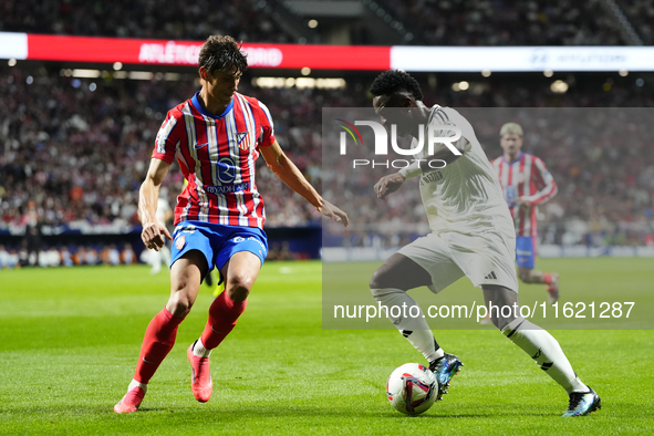 Vinicius Junior left winger of Real Madrid and Brazil and Robin Le Normand centre-back of Atletico de Madrid and Spaincompete for the ball d...