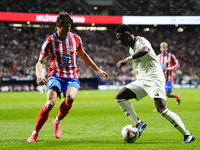 Vinicius Junior left winger of Real Madrid and Brazil and Robin Le Normand centre-back of Atletico de Madrid and Spaincompete for the ball d...