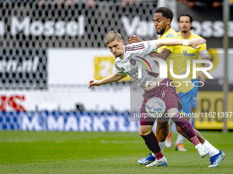 AFC Ajax Amsterdam midfielder Kenneth Taylor and RKC player Denilho Cleonise during the match RKC - Ajax at the Mandemakers Stadium for the...