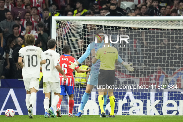 Thibaut Courtois goalkeeper of Real Madrid and Belgium talks to the referee about the throwing of objects by the Atletico supporters.during...