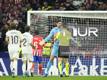 Thibaut Courtois goalkeeper of Real Madrid and Belgium talks to the referee about the throwing of objects by the Atletico supporters.during...