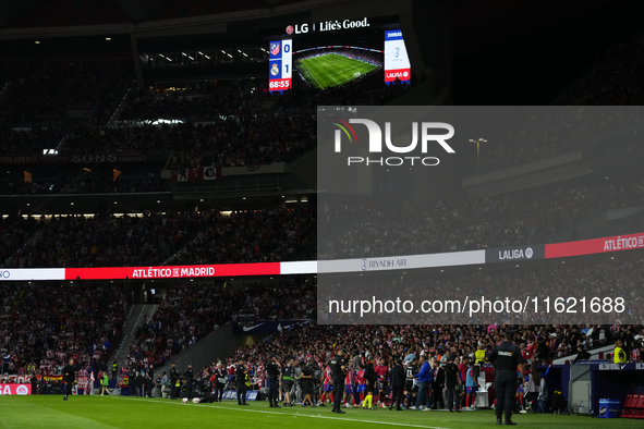 The players retire because of the temporary suspension of the match due to the throwing of objects.during the LaLiga match between Atletico...