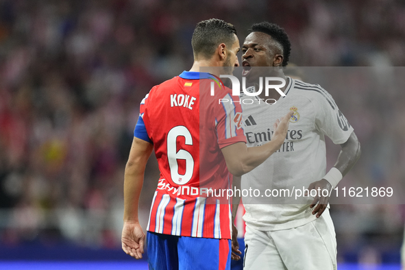 Vinicius Junior left winger of Real Madrid and Brazil and Koke Resurreccion central midfield of Atletico de Madrid and Spain  argues during...