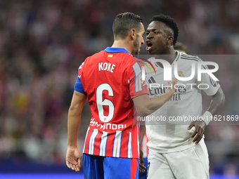 Vinicius Junior left winger of Real Madrid and Brazil and Koke Resurreccion central midfield of Atletico de Madrid and Spain  argues during...