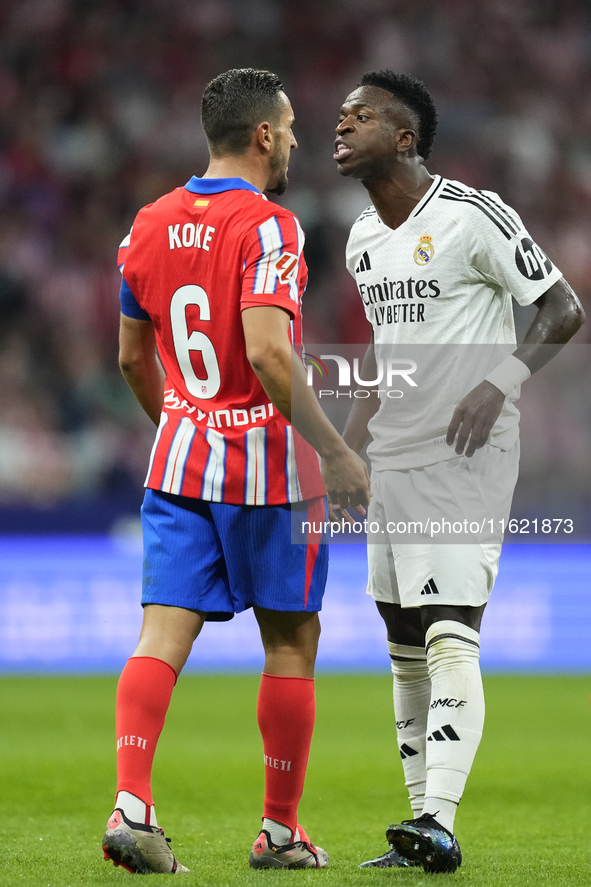 Vinicius Junior left winger of Real Madrid and Brazil and Koke Resurreccion central midfield of Atletico de Madrid and Spain  argues during...