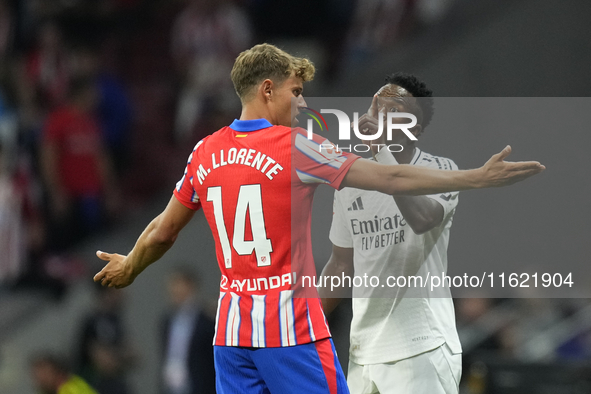 Vinicius Junior left winger of Real Madrid and Brazil and   Marcos Llorente central midfield of Atletico de Madrid and Spain argues during t...