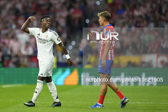 Vinicius Junior left winger of Real Madrid and Brazil and   Marcos Llorente central midfield of Atletico de Madrid and Spain argues during t...