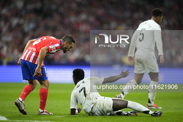 Vinicius Junior left winger of Real Madrid and Brazil and Koke Resurreccion central midfield of Atletico de Madrid and Spain  argues during...