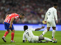 Vinicius Junior left winger of Real Madrid and Brazil and Koke Resurreccion central midfield of Atletico de Madrid and Spain  argues during...