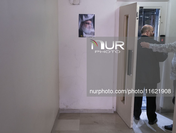 Khaled Qaddoumi, Hamas's representative in Tehran, enters an elevator next to a portrait of Lebanon's Hezbollah Secretary General, Hassan Na...