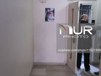 Khaled Qaddoumi, Hamas's representative in Tehran, enters an elevator next to a portrait of Lebanon's Hezbollah Secretary General, Hassan Na...