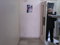 Khaled Qaddoumi, Hamas's representative in Tehran, enters an elevator next to a portrait of Lebanon's Hezbollah Secretary General, Hassan Na...