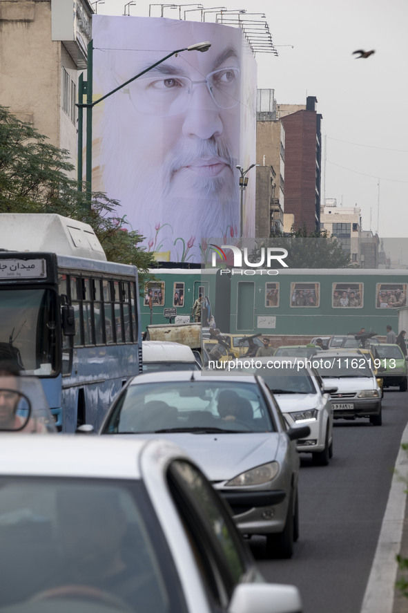 A giant banner featuring a portrait of Lebanon's Hezbollah Secretary General, Hassan Nasrallah, who was killed in an Israeli air strike in a...