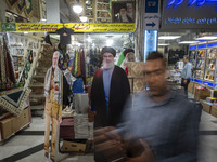 An Iranian man walks past an effigy of Lebanon's Hezbollah Secretary General, Hassan Nasrallah, who was killed in an Israeli air strike in a...