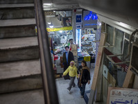 An Iranian woman and her young daughter walk past an effigy of Lebanon's Hezbollah Secretary General, Hassan Nasrallah, who was killed in an...