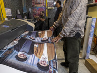 A banner depicting Hassan Nasrallah, Secretary General of Lebanon's Hezbollah, and Iran's Supreme Leader, Ayatollah Ali Khamenei, is printed...