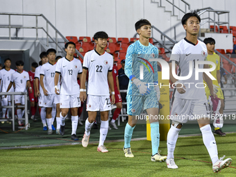 Hong Kong, China, and Singapore players walk onto the pitch before the 2025 AFC U20 Asian Cup Qualifiers Group J match between Singapore and...