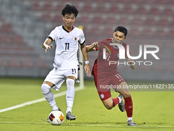 Fairuz Fazli (R) of Singapore battles for the ball with Ho Tung Lam (L) of Hong Kong, China, during the 2025 AFC U20 Asian Cup Qualifiers Gr...