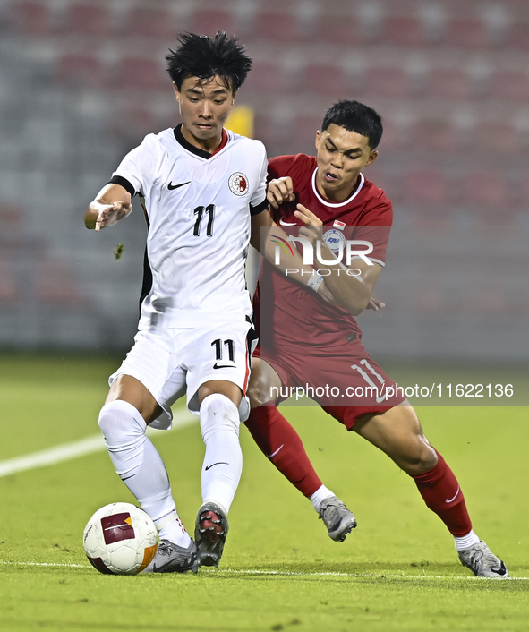 Fairuz Fazli (R) of Singapore battles for the ball with Ho Tung Lam (L) of Hong Kong, China, during the 2025 AFC U20 Asian Cup Qualifiers Gr...