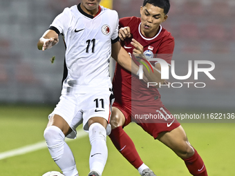 Fairuz Fazli (R) of Singapore battles for the ball with Ho Tung Lam (L) of Hong Kong, China, during the 2025 AFC U20 Asian Cup Qualifiers Gr...