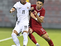 Fairuz Fazli (R) of Singapore battles for the ball with Ho Tung Lam (L) of Hong Kong, China, during the 2025 AFC U20 Asian Cup Qualifiers Gr...