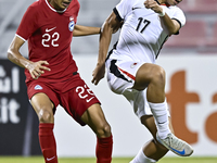 Muhammad Hud Bin Muhammad Ismail (L) of Singapore battles for the ball with Lam Ho Hei (R) of Hong Kong, China, during the 2025 AFC U20 Asia...