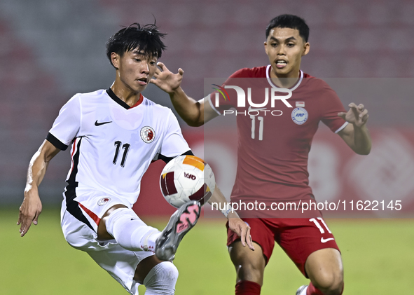 Fairuz Fazli (R) of Singapore battles for the ball with Ho Tung Lam (L) of Hong Kong, China, during the 2025 AFC U20 Asian Cup Qualifiers Gr...