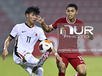 Fairuz Fazli (R) of Singapore battles for the ball with Ho Tung Lam (L) of Hong Kong, China, during the 2025 AFC U20 Asian Cup Qualifiers Gr...