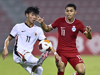 Fairuz Fazli (R) of Singapore battles for the ball with Ho Tung Lam (L) of Hong Kong, China, during the 2025 AFC U20 Asian Cup Qualifiers Gr...