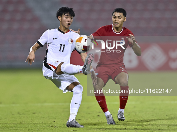 Fairuz Fazli (R) of Singapore battles for the ball with Ho Tung Lam (L) of Hong Kong, China, during the 2025 AFC U20 Asian Cup Qualifiers Gr...