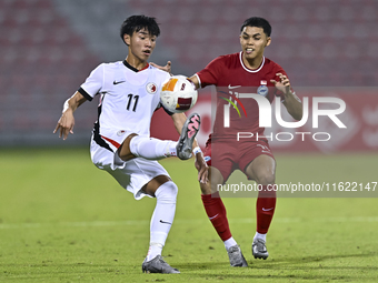 Fairuz Fazli (R) of Singapore battles for the ball with Ho Tung Lam (L) of Hong Kong, China, during the 2025 AFC U20 Asian Cup Qualifiers Gr...