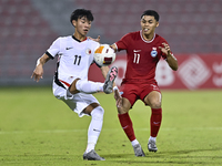 Fairuz Fazli (R) of Singapore battles for the ball with Ho Tung Lam (L) of Hong Kong, China, during the 2025 AFC U20 Asian Cup Qualifiers Gr...