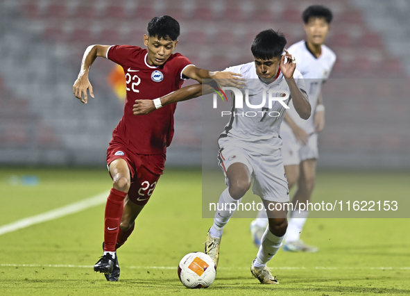 Muhammad Hud Bin Muhammad Ismail (L) of Singapore battles for the ball with Anthony Francis Pinto (R) of Hong Kong, China, during the 2025 A...