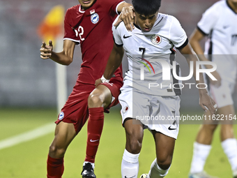 Muhammad Hud Bin Muhammad Ismail (L) of Singapore battles for the ball with Anthony Francis Pinto (R) of Hong Kong, China, during the 2025 A...