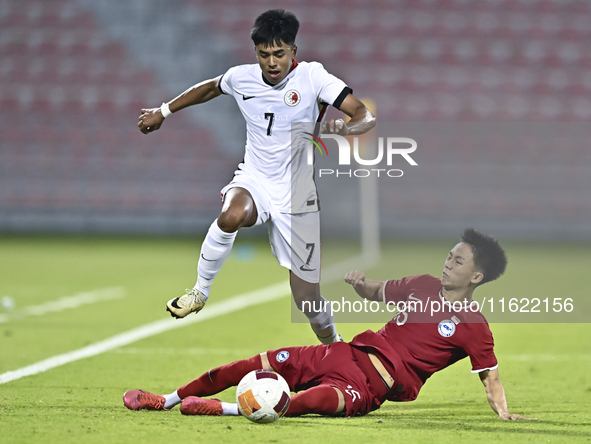 Lim Zheng Wu (bottom) of Singapore battles for the ball with Anthony Francis Pinto (left) of Hong Kong, China, during the 2025 AFC U20 Asian...