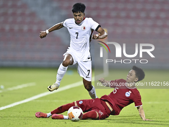 Lim Zheng Wu (bottom) of Singapore battles for the ball with Anthony Francis Pinto (left) of Hong Kong, China, during the 2025 AFC U20 Asian...