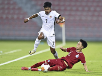 Lim Zheng Wu (bottom) of Singapore battles for the ball with Anthony Francis Pinto (left) of Hong Kong, China, during the 2025 AFC U20 Asian...