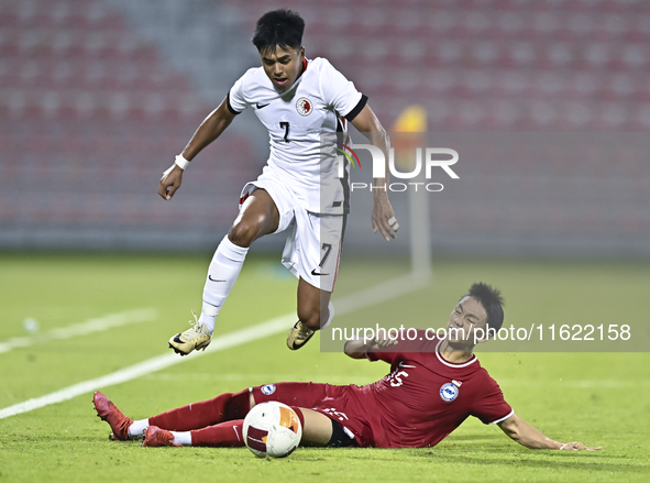 Lim Zheng Wu (bottom) of Singapore battles for the ball with Anthony Francis Pinto (left) of Hong Kong, China, during the 2025 AFC U20 Asian...