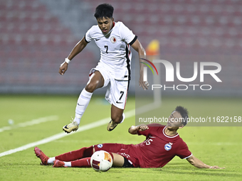 Lim Zheng Wu (bottom) of Singapore battles for the ball with Anthony Francis Pinto (left) of Hong Kong, China, during the 2025 AFC U20 Asian...