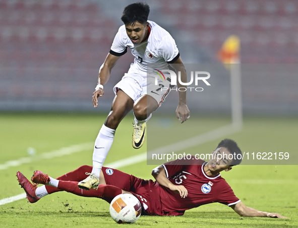 Lim Zheng Wu (bottom) of Singapore battles for the ball with Anthony Francis Pinto (left) of Hong Kong, China, during the 2025 AFC U20 Asian...