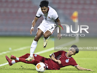 Lim Zheng Wu (bottom) of Singapore battles for the ball with Anthony Francis Pinto (left) of Hong Kong, China, during the 2025 AFC U20 Asian...