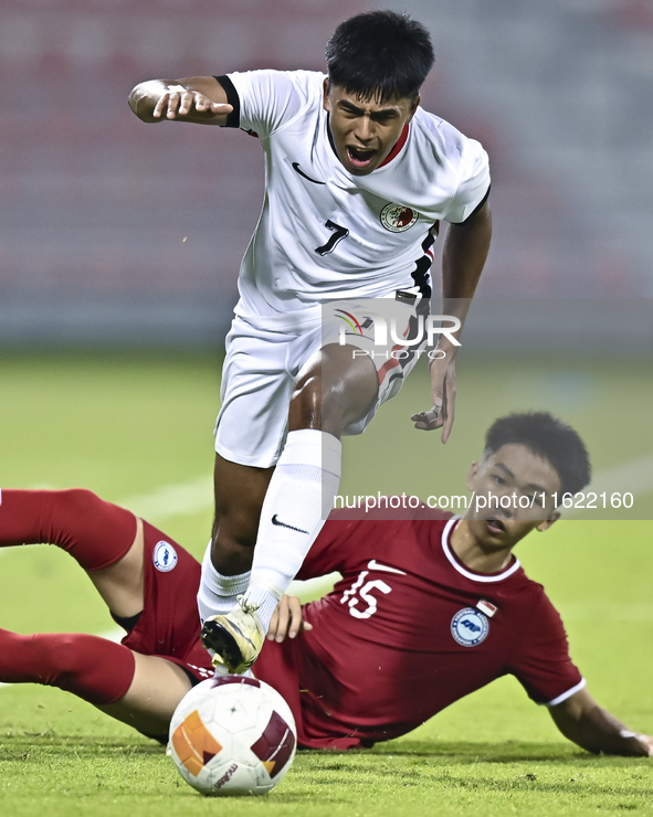 Lim Zheng Wu (bottom) of Singapore battles for the ball with Anthony Francis Pinto (left) of Hong Kong, China, during the 2025 AFC U20 Asian...