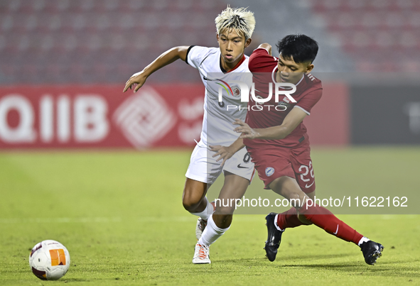 Muhammad Hud Bin Muhammad Ismail (R) of Singapore battles for the ball with Yuen Chun Him (L) of Hong Kong, China, during the 2025 AFC U20 A...