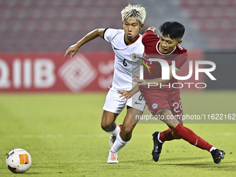 Muhammad Hud Bin Muhammad Ismail (R) of Singapore battles for the ball with Yuen Chun Him (L) of Hong Kong, China, during the 2025 AFC U20 A...