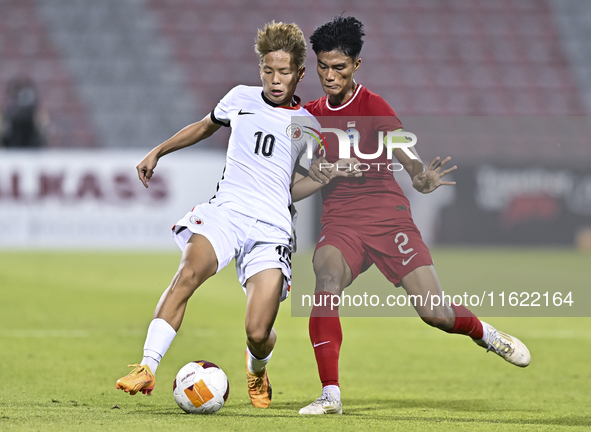 Raoul Suhaimi (R) of Singapore battles for the ball with Chiu Ching Yu Sergio (L) of Hong Kong, China, during the 2025 AFC U20 Asian Cup Qua...