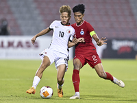 Raoul Suhaimi (R) of Singapore battles for the ball with Chiu Ching Yu Sergio (L) of Hong Kong, China, during the 2025 AFC U20 Asian Cup Qua...