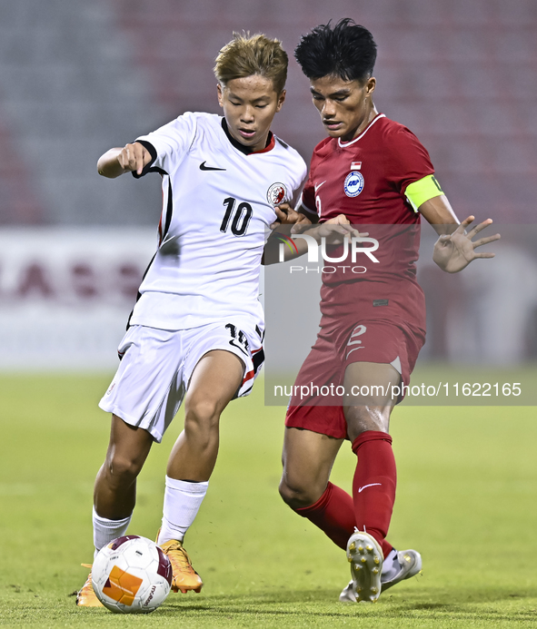 Raoul Suhaimi (R) of Singapore battles for the ball with Chiu Ching Yu Sergio (L) of Hong Kong, China, during the 2025 AFC U20 Asian Cup Qua...