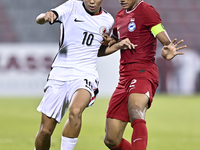 Raoul Suhaimi (R) of Singapore battles for the ball with Chiu Ching Yu Sergio (L) of Hong Kong, China, during the 2025 AFC U20 Asian Cup Qua...